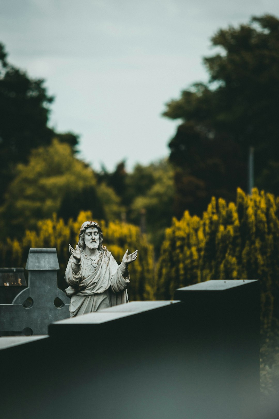 gray concrete statue on black wooden table