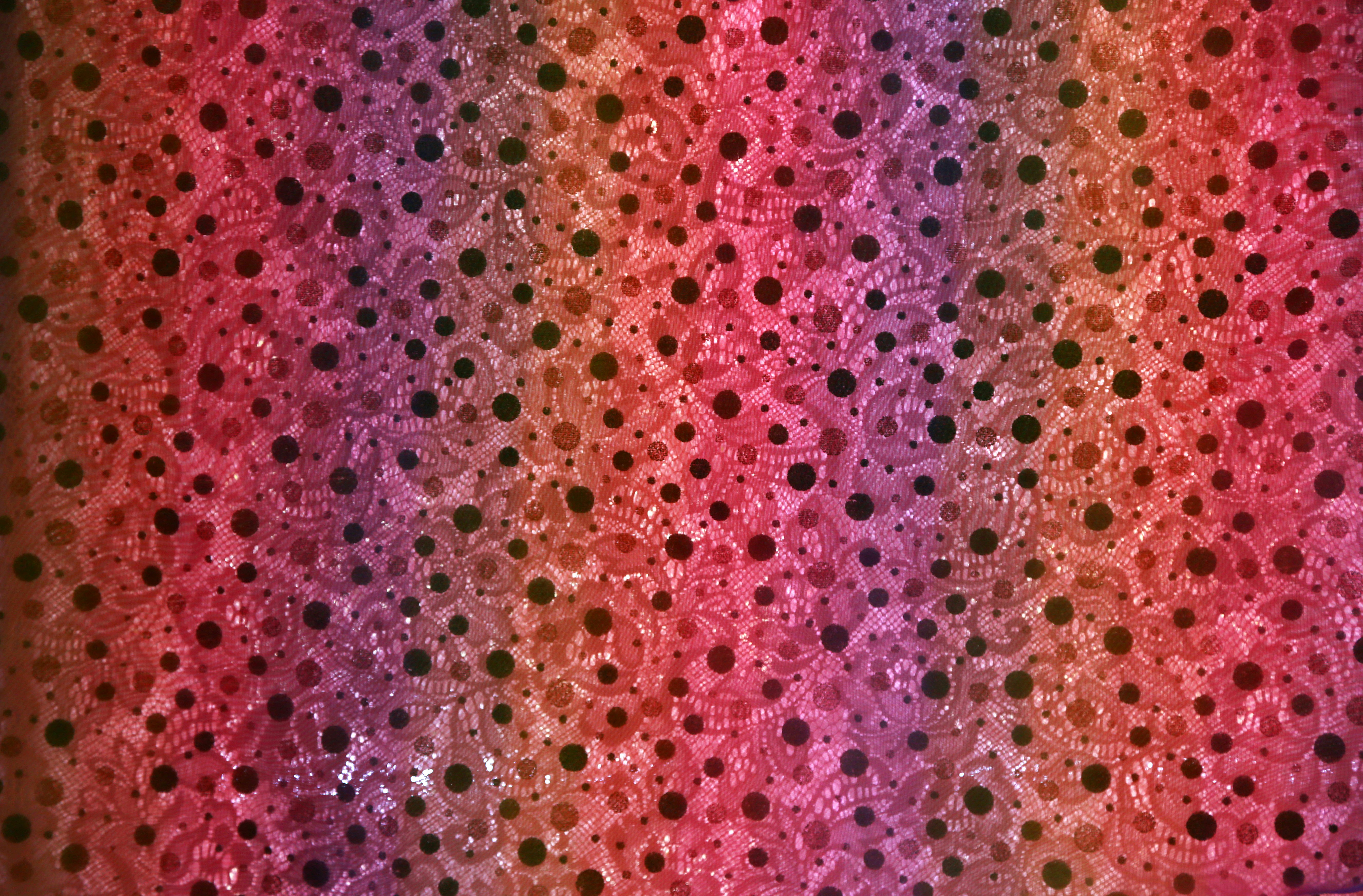 pink and white polka dot textile