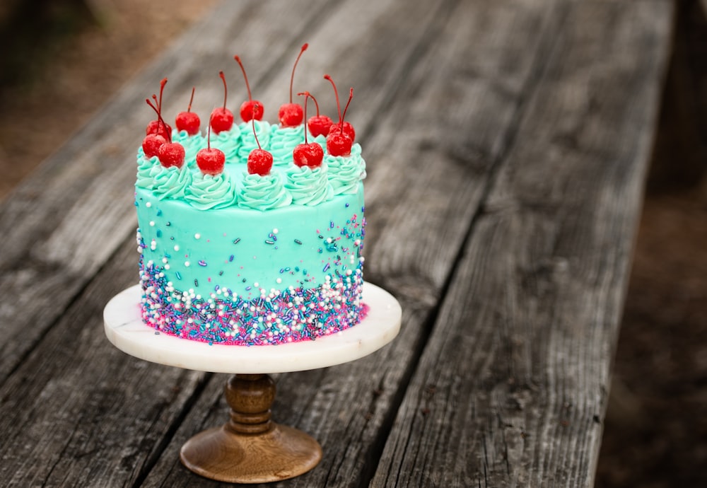white and blue cake with strawberry on top