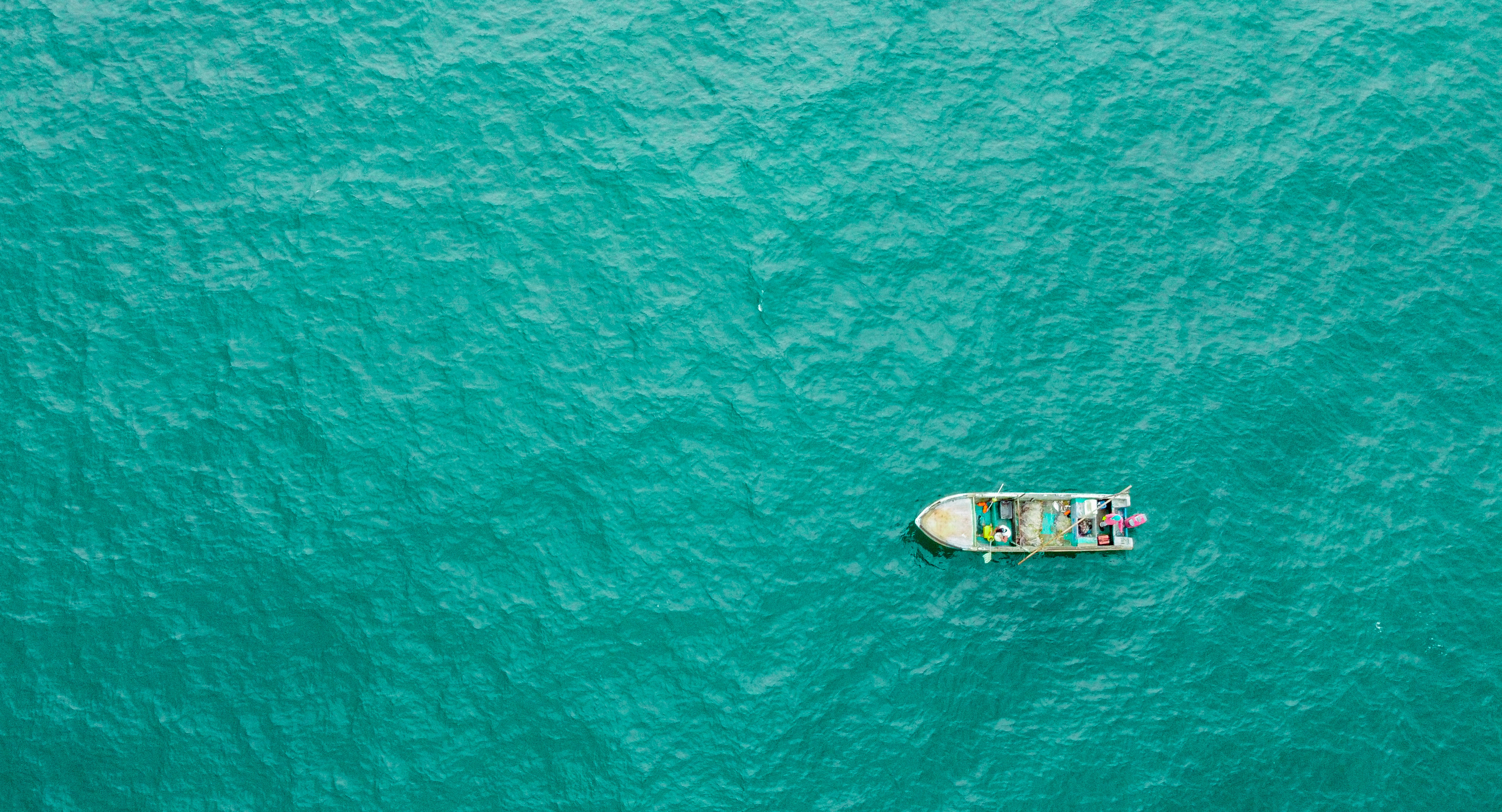 aerial view of white and brown boat on sea during daytime