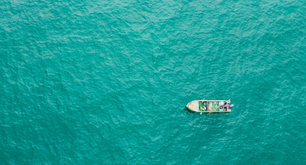 aerial view of white and brown boat on sea during daytime