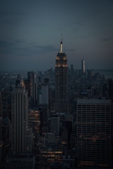 A dramatic nighttime cityscape shot with moody lighting and sharp focus.