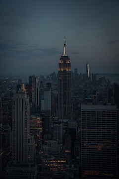 A dramatic nighttime cityscape shot with moody lighting and sharp focus.
