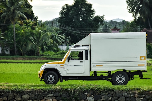 white truck on green grass field during daytime