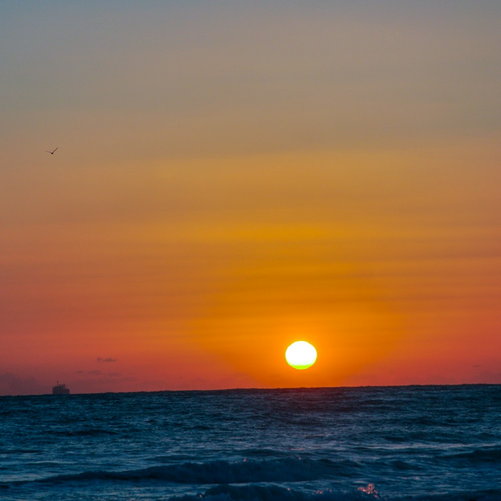 body of water during sunset