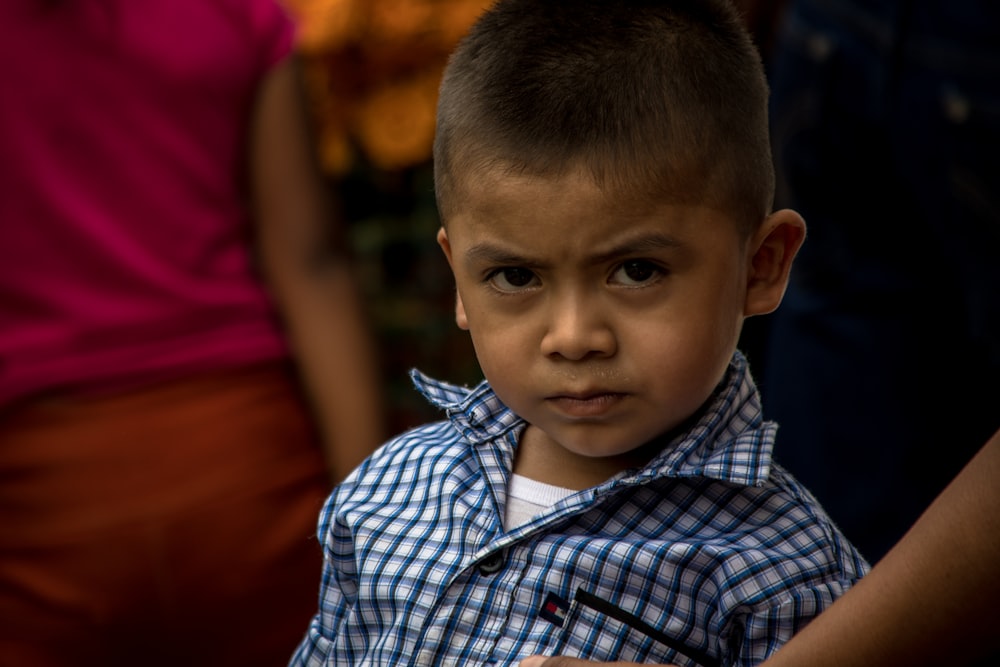 boy in blue and white plaid button up shirt