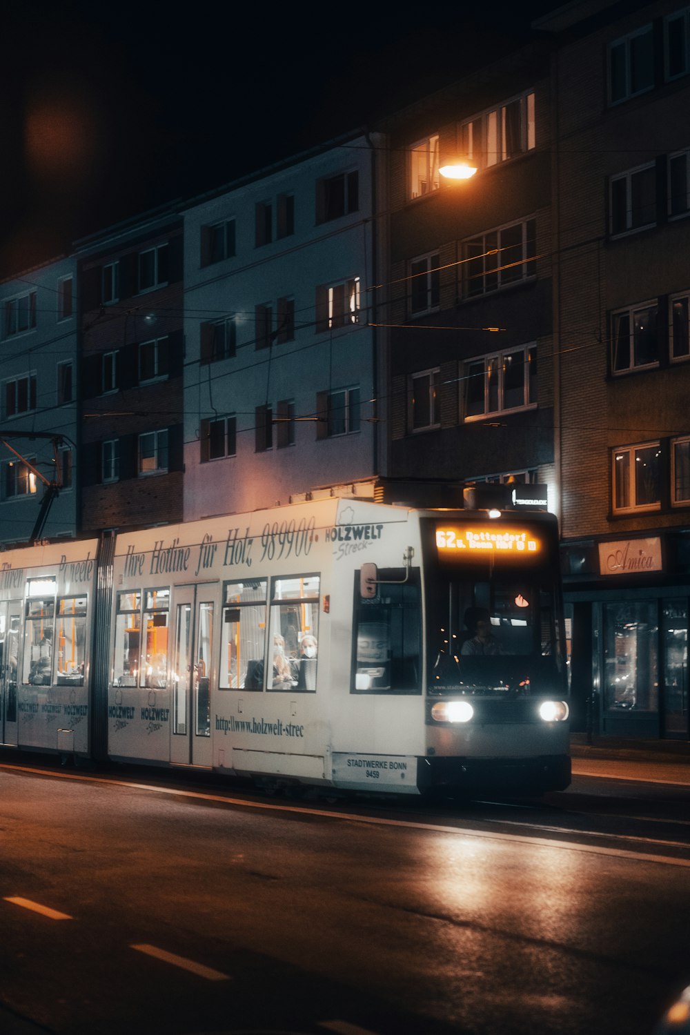 white and blue tram on road near building during daytime