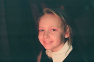A candid street photograph capturing a fleeting smile under soft white morning light.