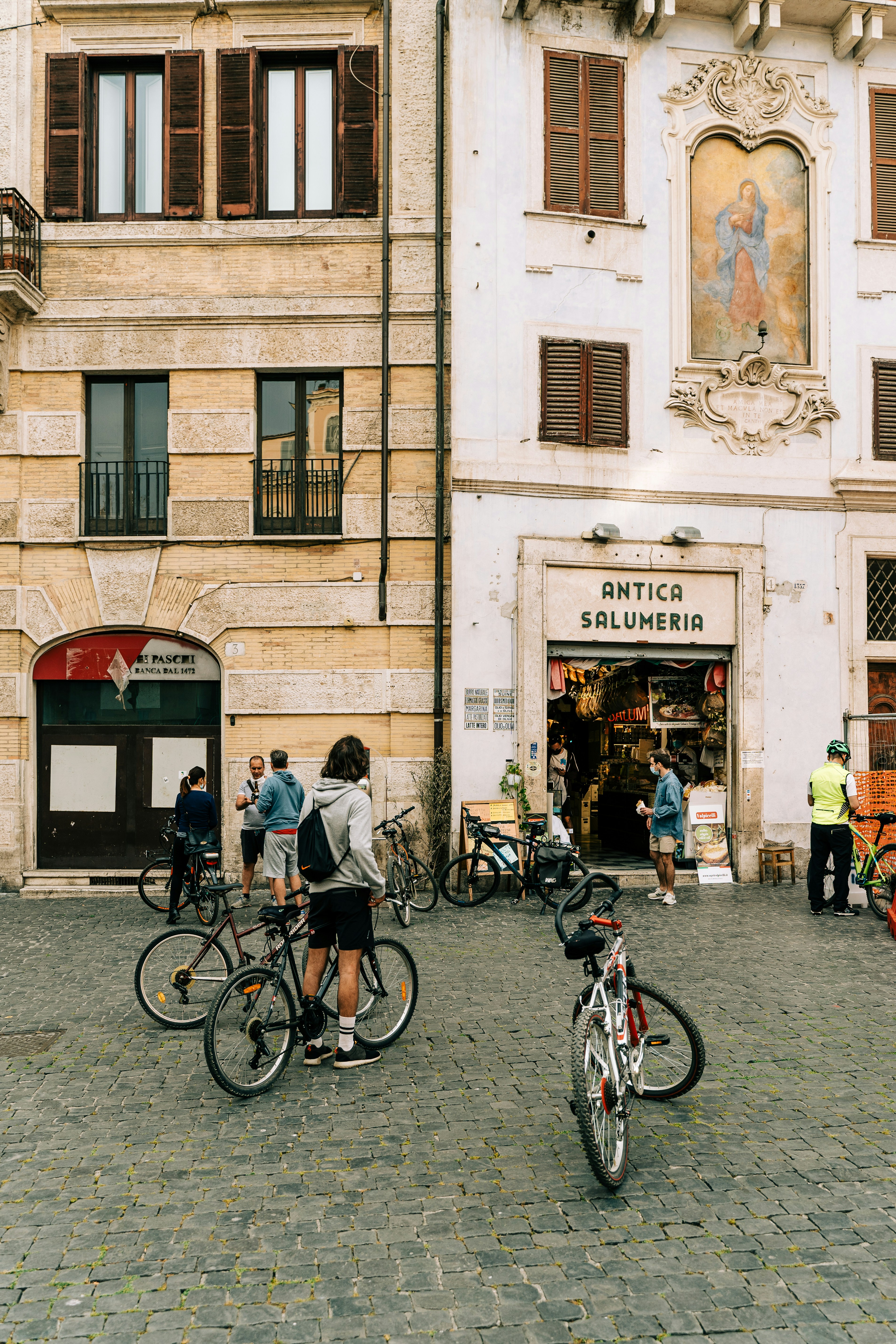 man and woman riding bicycle on street during daytime
