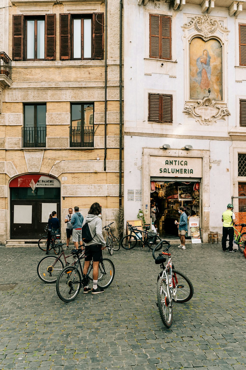 man and woman riding bicycle on street during daytime