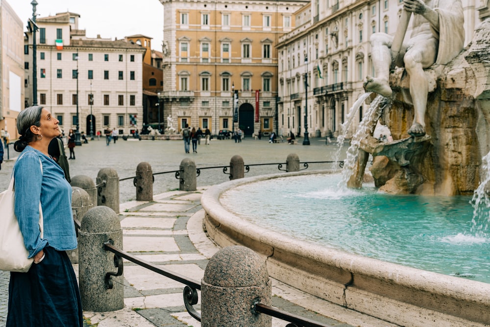 people walking on street near water fountain during daytime