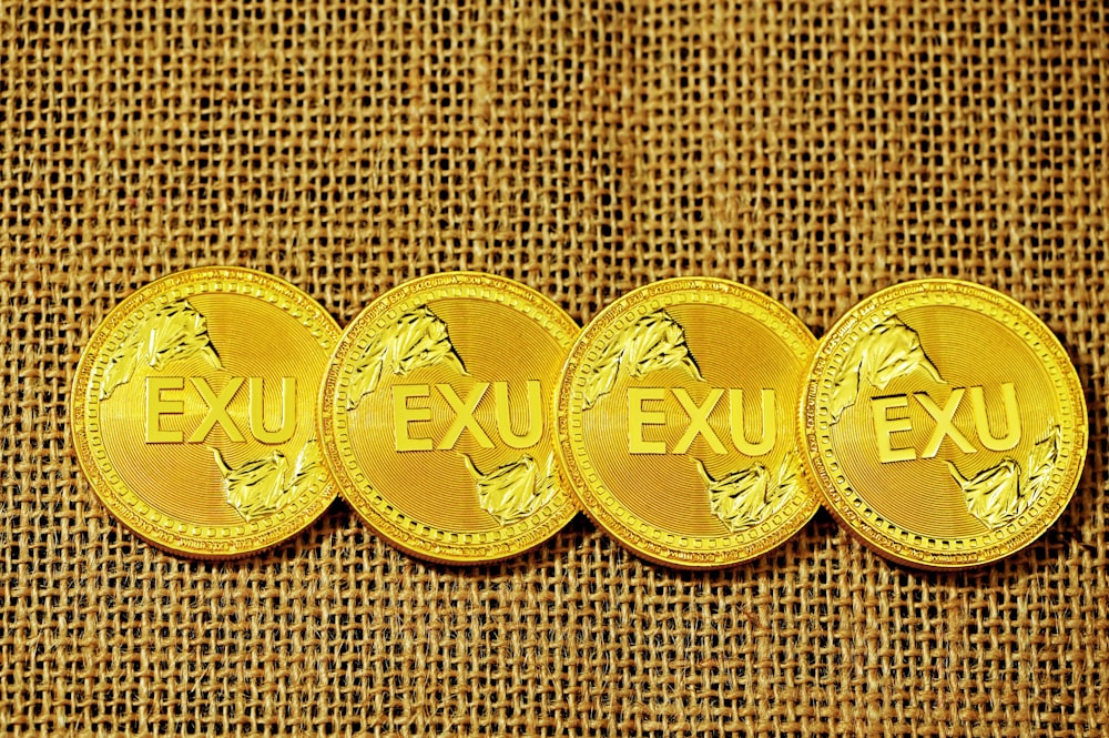 a row of gold coins sitting on top of a brown cloth