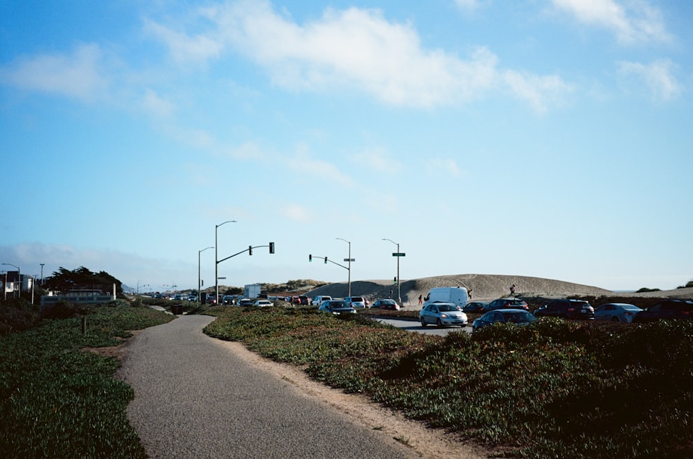 cars parked on parking lot under blue sky during daytime