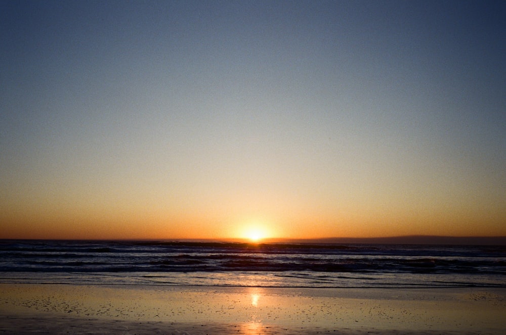 body of water during sunset