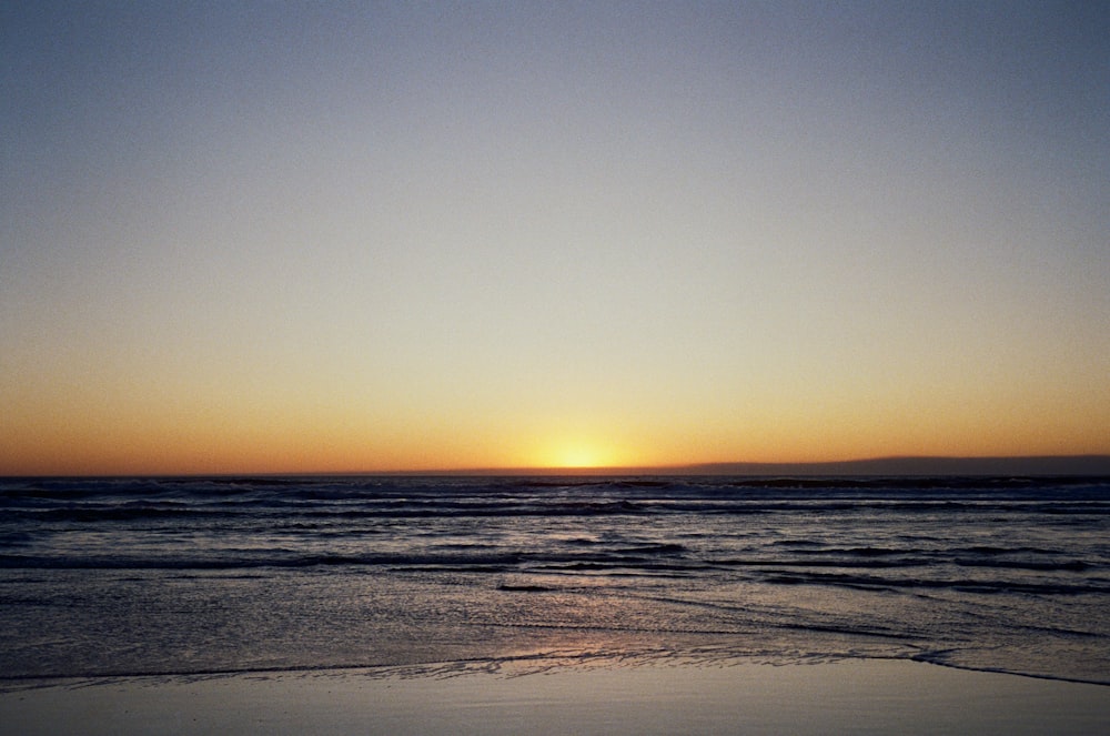 body of water during sunset