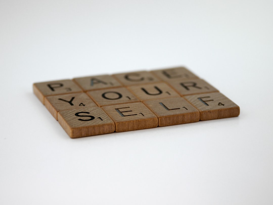 brown wooden letter blocks on white surface