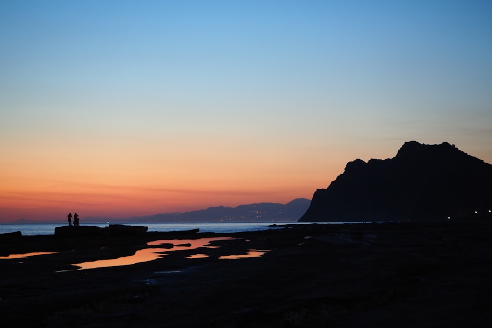 silhouette of mountain during sunset