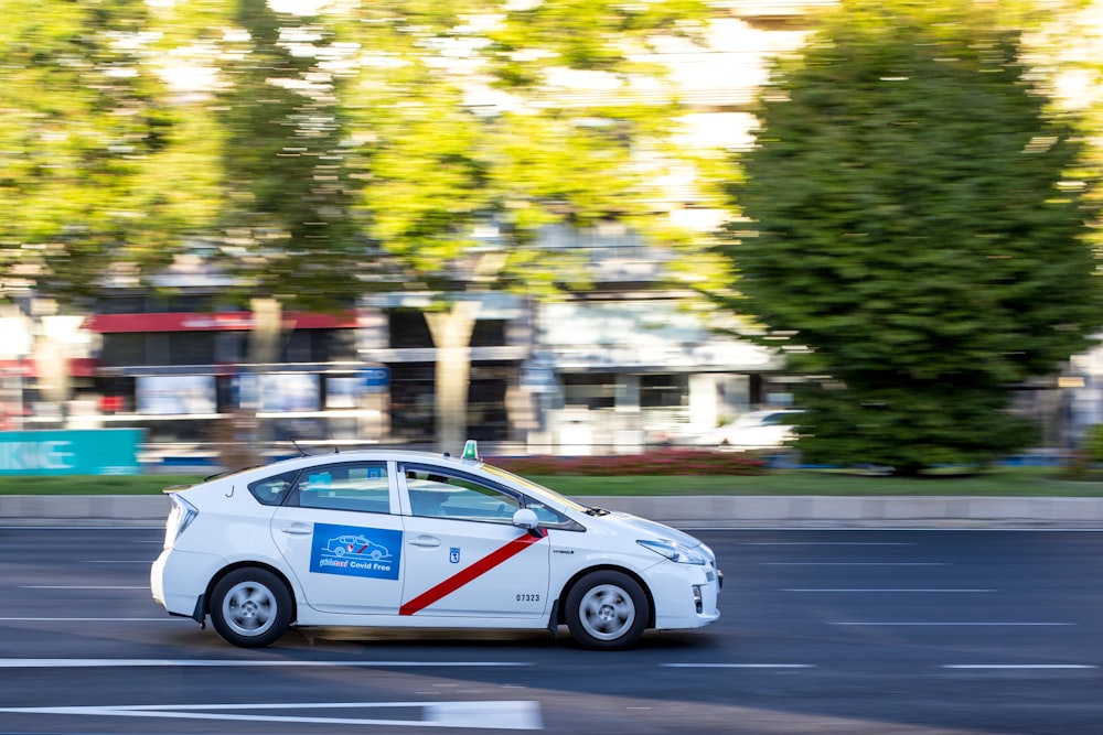 white sedan on road during daytime