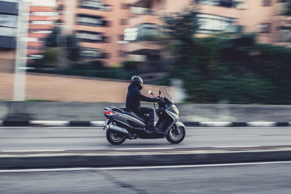 man riding motorcycle on road during daytime