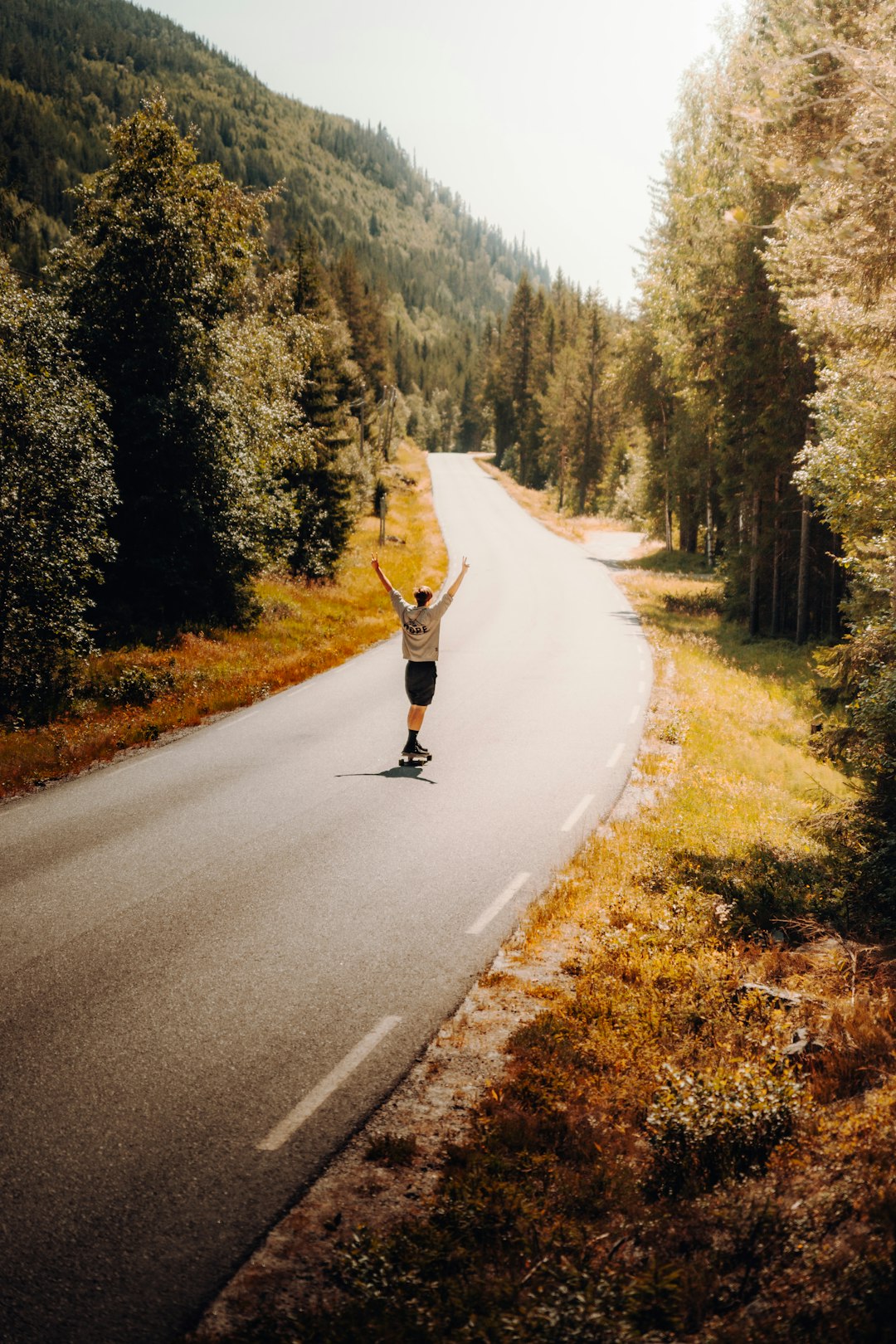 man in black jacket and blue denim jeans running on road during daytime