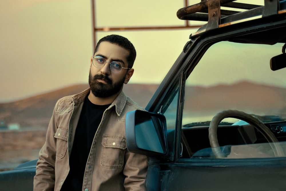 man in gray button up shirt wearing black framed eyeglasses