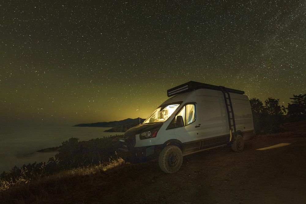 white suv on brown field during night time