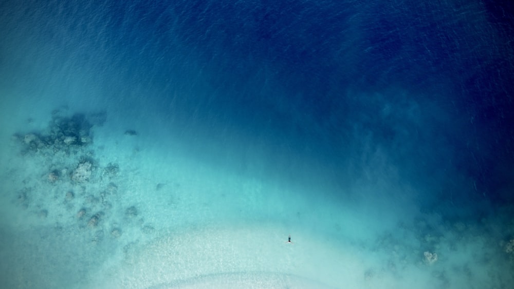 an aerial view of a sandy beach and ocean