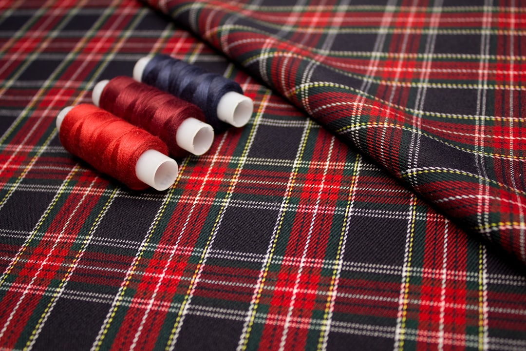 red and white thread on red and white plaid textile,