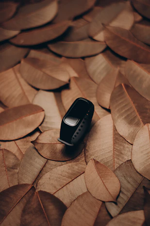 A neatly arranged collection of fitness watches and heart rate monitors on a rustic table.