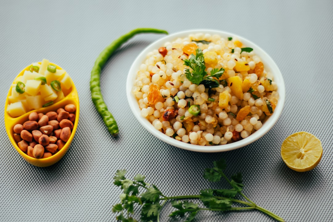 white ceramic bowl with corn and green leaf vegetable