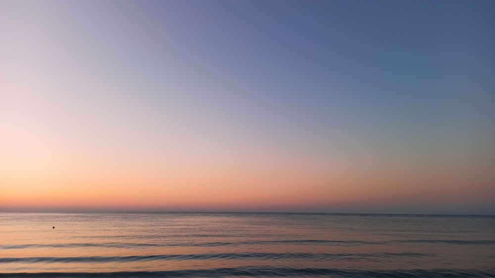 body of water during sunset