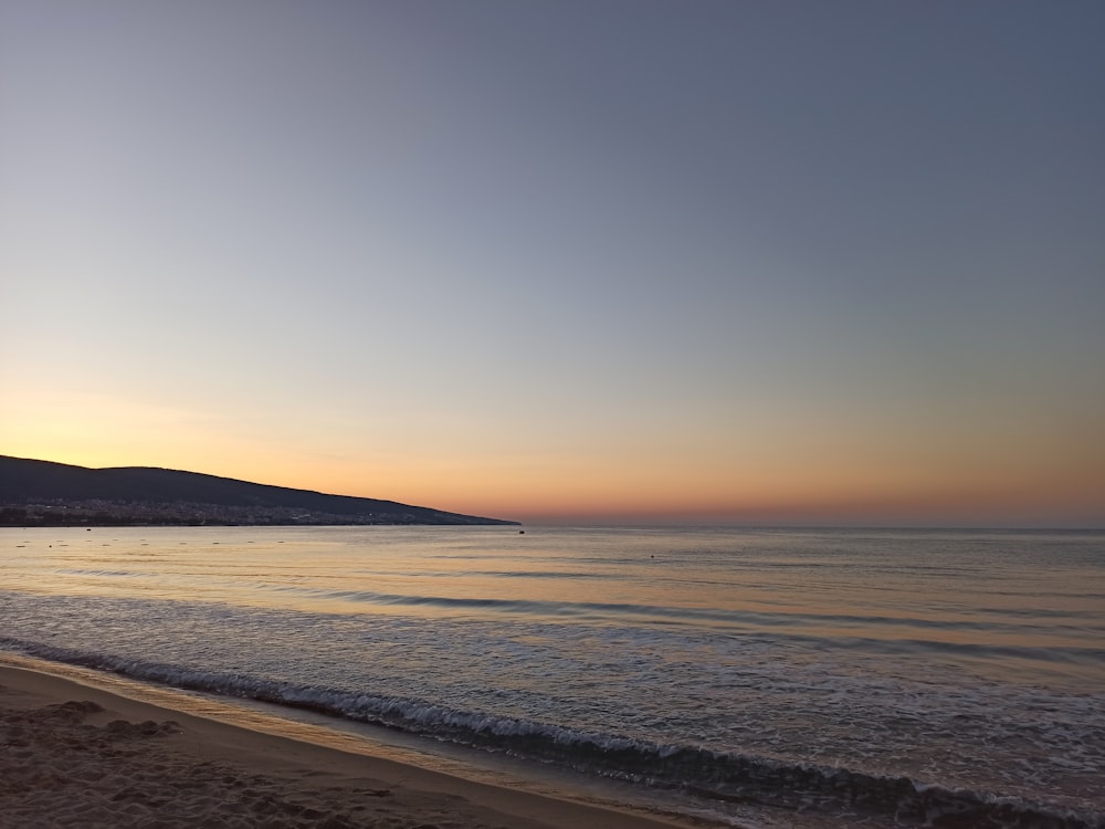 body of water during sunset