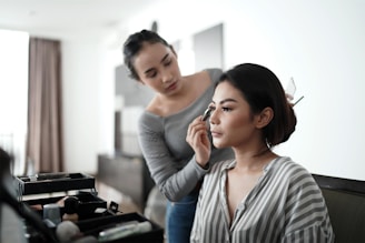 woman in gray cardigan holding her face