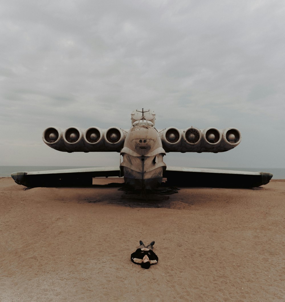 a small airplane sitting on top of a sandy beach