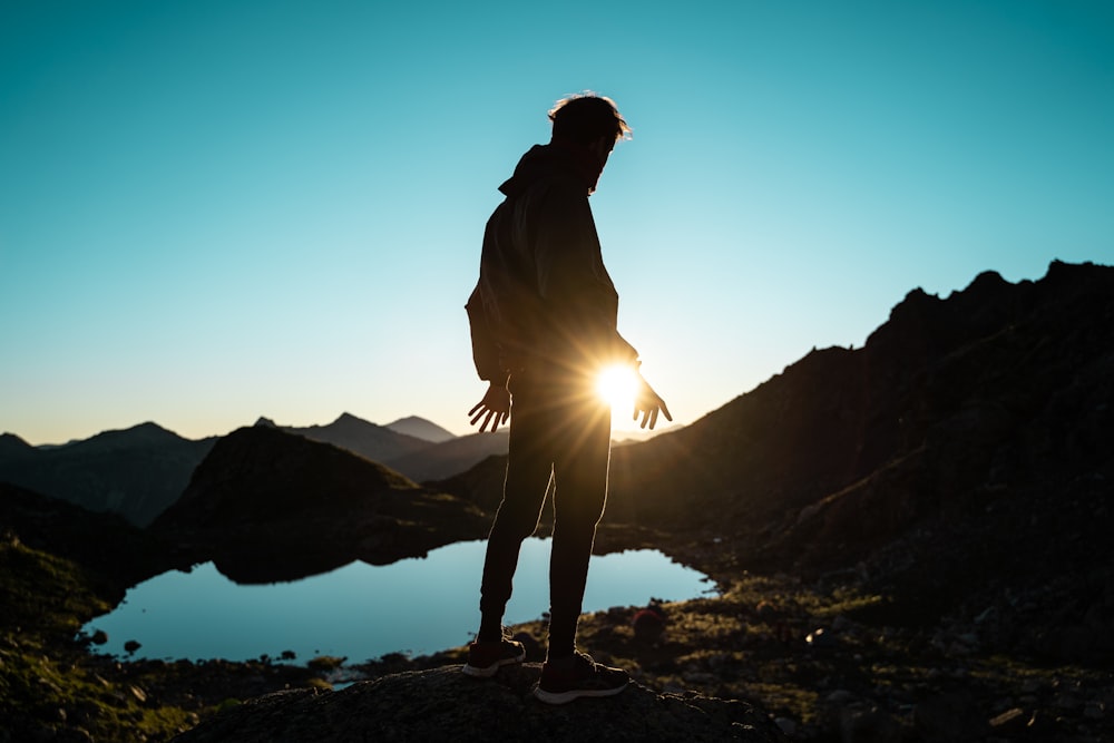 silhouette of person standing on rocky ground during daytime photo – Free  Mounatins Image on Unsplash