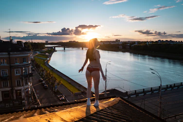 woman in pink bikini standing on dock during daytime