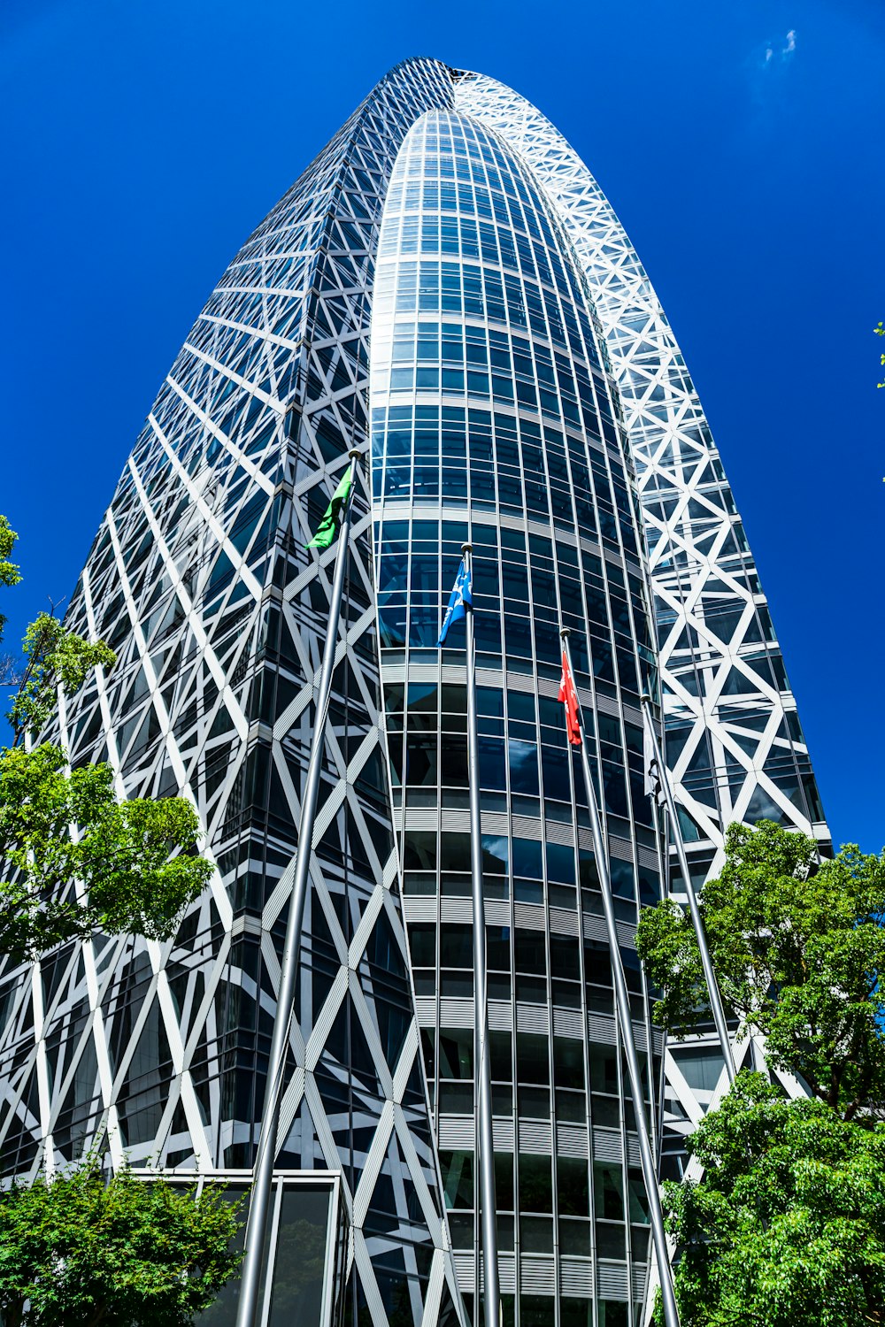 white and black building near green trees during daytime