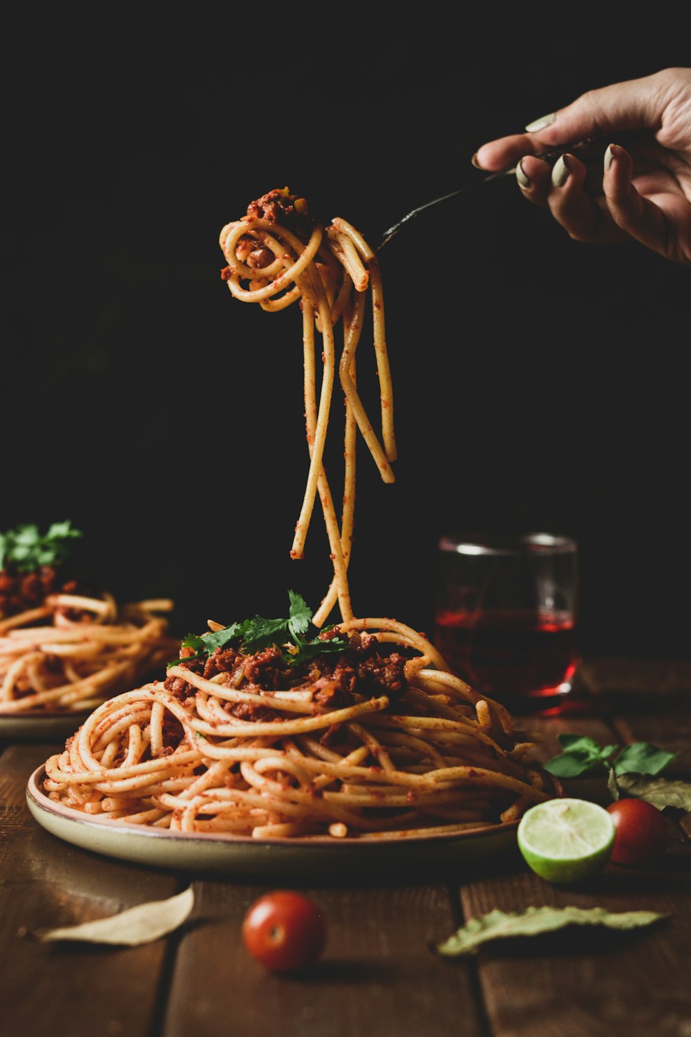 pasta with green leaves on brown ceramic plate