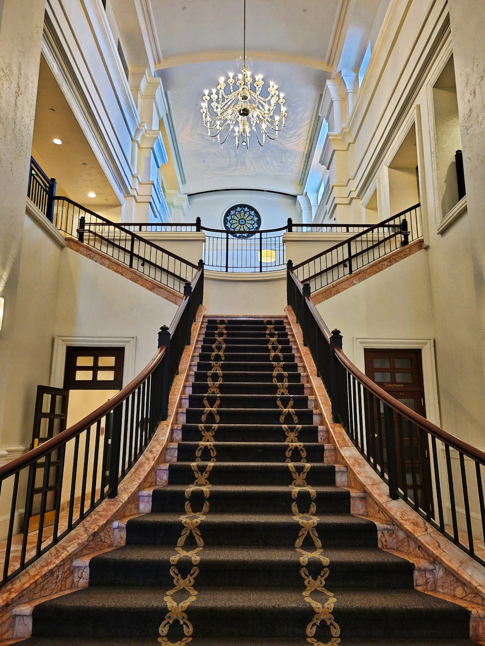 brown wooden staircase in white painted building