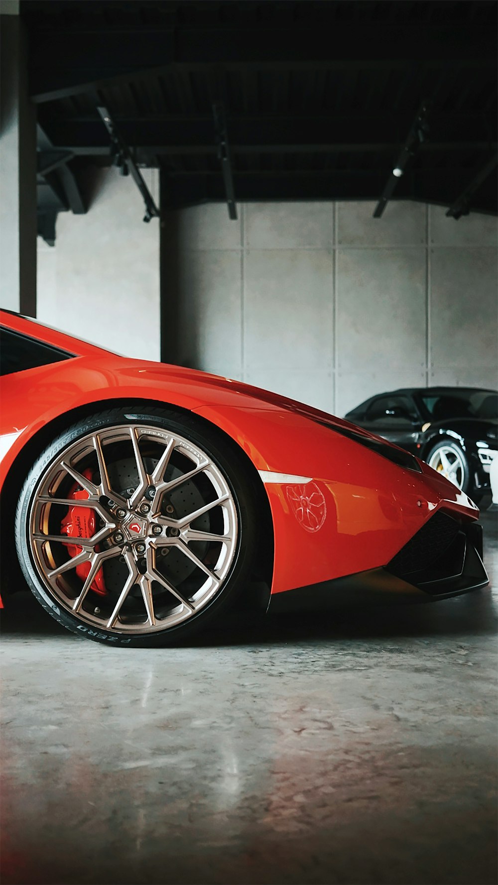 red ferrari 458 italia parked near white wall