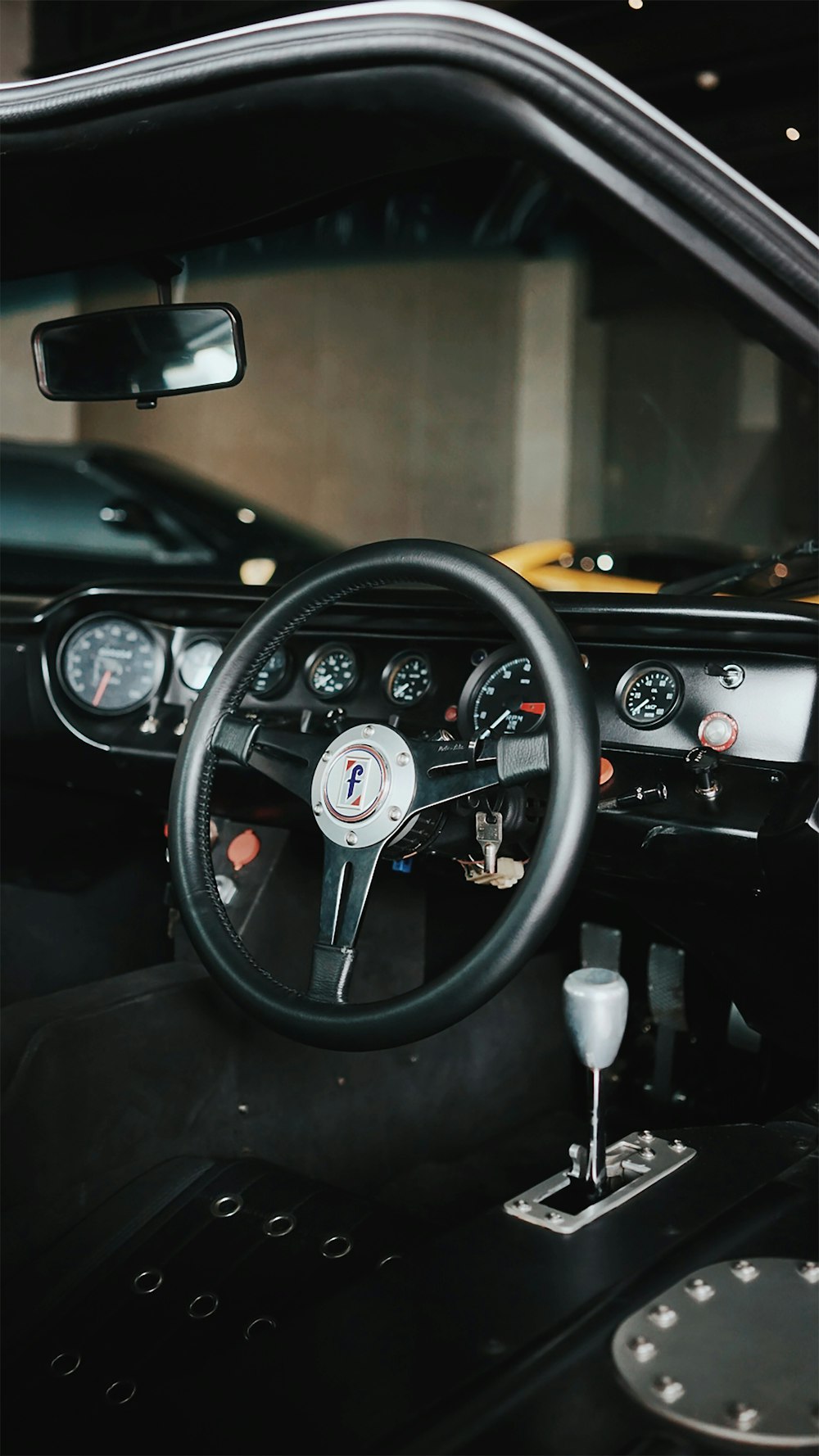 black steering wheel in close up photography