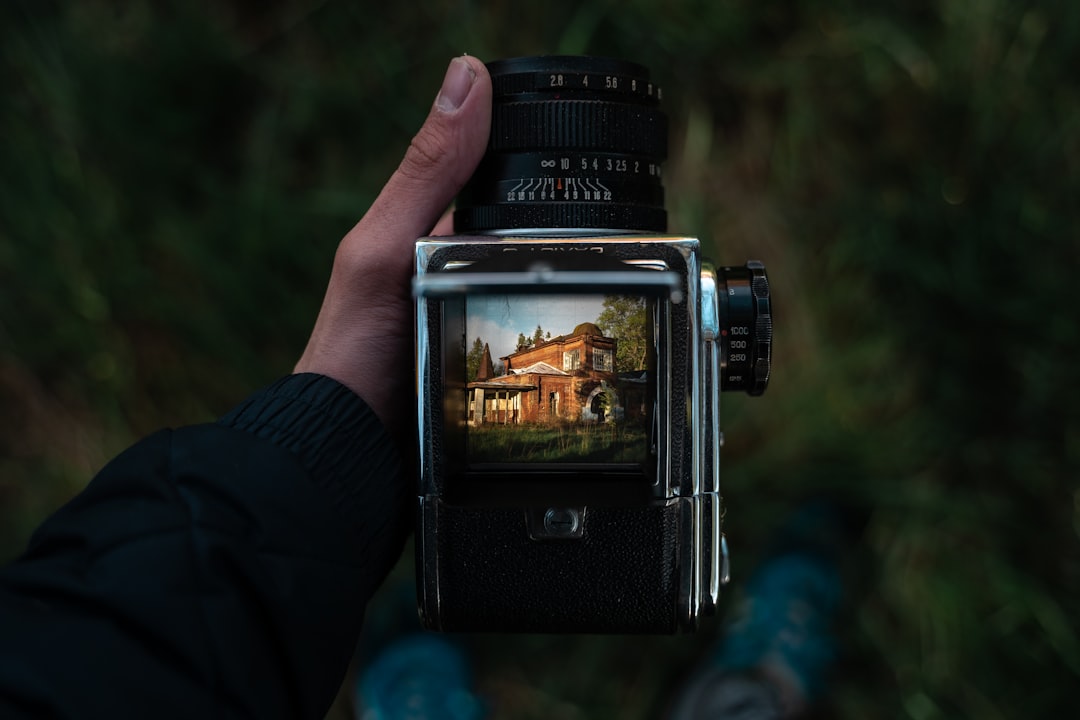 person holding black nikon dslr camera