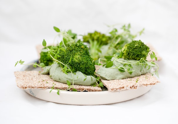 green vegetable on brown wooden round plate