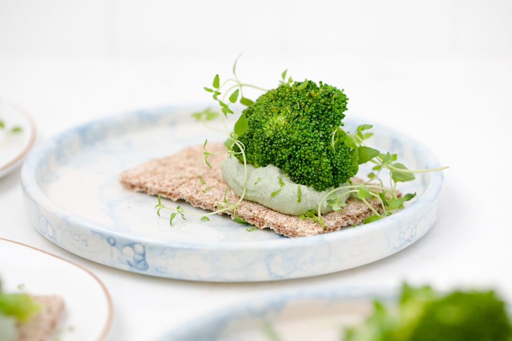 green vegetable on white ceramic plate