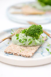 green vegetable on white ceramic plate