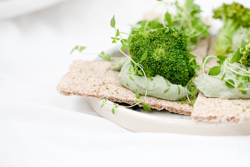 green and brown vegetable on white ceramic plate