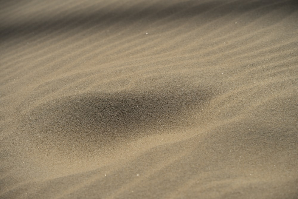 a sand dune with a small circle in the sand