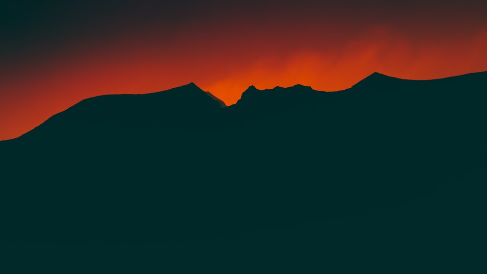 silhouette of mountain during sunset