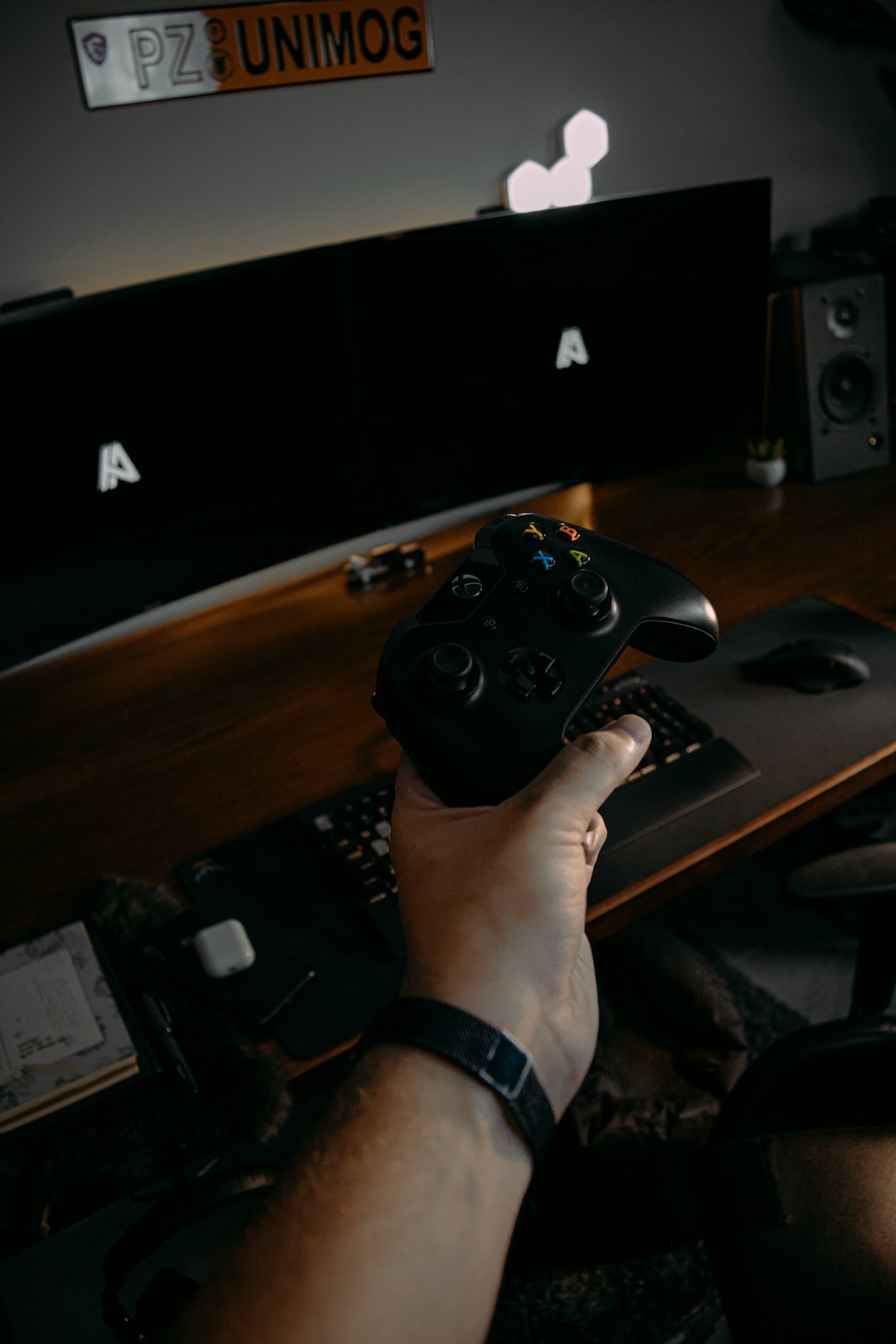 person holding black xbox one game controller