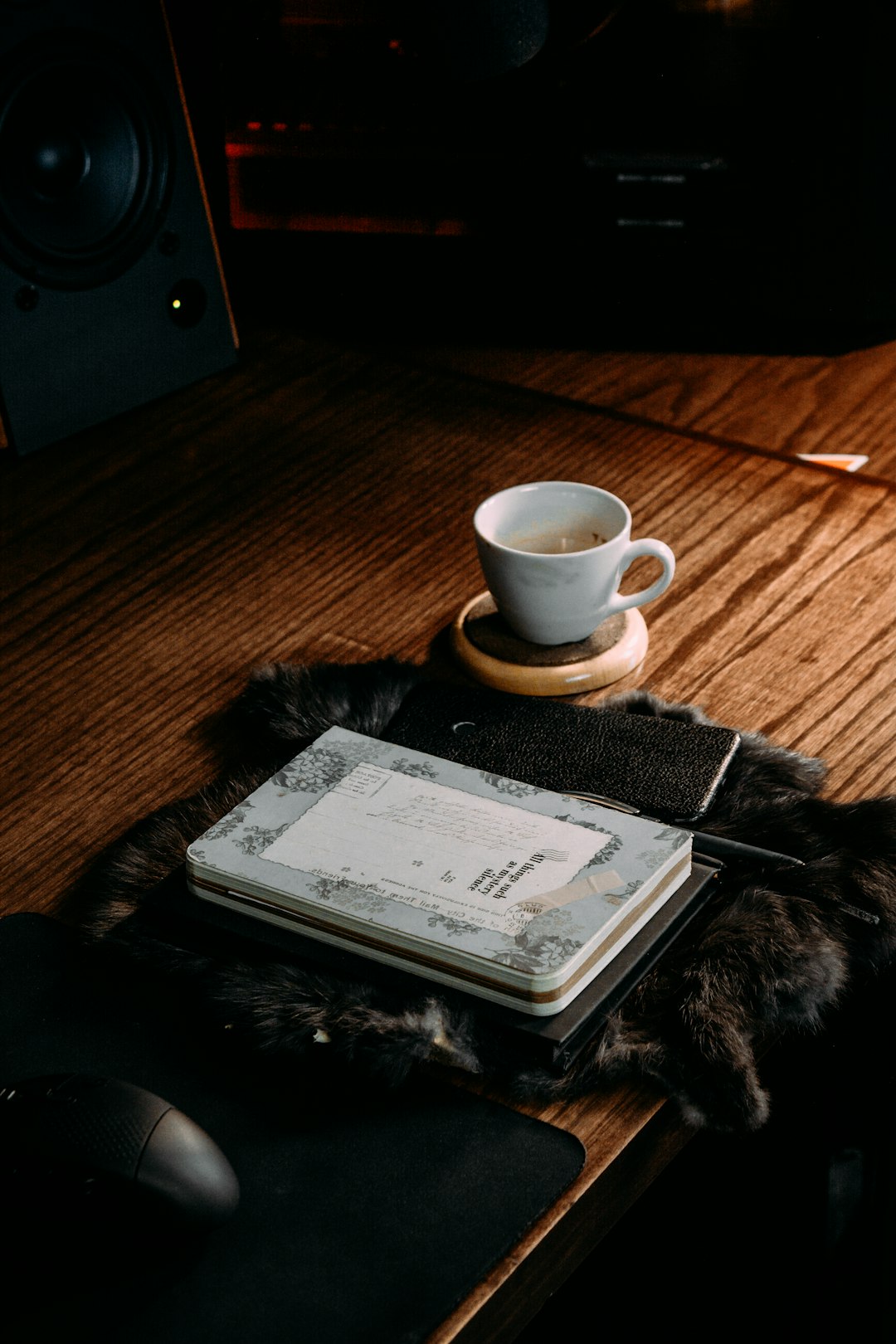 white ceramic mug on black book